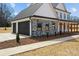 Attached two-car garage with stone accents and modern black doors, seamlessly blending with the farmhouse architecture at 1695 Agner Rd, Salisbury, NC 28146