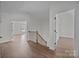 Inviting hallway with hardwood floors, staircase, and doorways leading to various rooms at 1695 Agner Rd, Salisbury, NC 28146