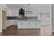 White kitchen featuring an island, white cabinets, stainless steel appliances and modern backsplash at 1695 Agner Rd, Salisbury, NC 28146