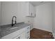 Functional laundry room features granite counters, white cabinets, and a modern sink at 1695 Agner Rd, Salisbury, NC 28146