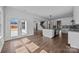 Expansive open floor plan with kitchen island, dark wood flooring, and abundant natural light at 1695 Agner Rd, Salisbury, NC 28146