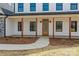 Welcoming front porch with wood columns and a charming entrance, complemented by neat landscaping and a concrete pathway at 1695 Agner Rd, Salisbury, NC 28146