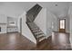 Elegant staircase featuring wooden steps, iron railings, and white trim at 1695 Agner Rd, Salisbury, NC 28146