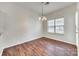 Dining area featuring a modern chandelier, a window, and hardwood floors at 2035 Lennox Square Rd, Charlotte, NC 28210