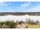 Expansive aerial view of home on the water featuring mature trees and a long driveway at 225 Kirkpatrick Rd, Taylorsville, NC 28681