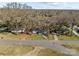 An aerial view of a neighborhood shows a home with a yard, mature trees, and street access at 2418 Acapulco Dr, Gastonia, NC 28054