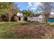 Large backyard with several outbuildings and lots of mature trees at 2418 Acapulco Dr, Gastonia, NC 28054