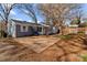 Back exterior of the home with a sunroom and large patio area at 2418 Acapulco Dr, Gastonia, NC 28054