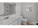 Bathroom with white tiled walls, a marble countertop sink, and wood floors at 2418 Acapulco Dr, Gastonia, NC 28054