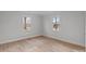 Bright bedroom with light-colored walls, trim, and floors featuring two windows at 2418 Acapulco Dr, Gastonia, NC 28054