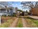 Long driveway extends to a two car garage with a wooden fence separating properties at 2418 Acapulco Dr, Gastonia, NC 28054