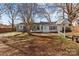 Charming single-story home with a small porch swing and a combination of white and gray siding at 2418 Acapulco Dr, Gastonia, NC 28054