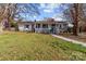 Charming home featuring a covered front porch, walkway, and nicely maintained front yard at 2418 Acapulco Dr, Gastonia, NC 28054