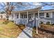 Charming home featuring a covered front porch with white columns and a brick foundation at 2418 Acapulco Dr, Gastonia, NC 28054