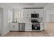 Modern kitchen equipped with stainless steel appliances, stylish backsplash, and ample white cabinetry at 2418 Acapulco Dr, Gastonia, NC 28054