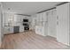 Open kitchen boasting white cabinets, stainless steel appliances, and light wood flooring at 2418 Acapulco Dr, Gastonia, NC 28054