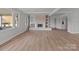 Open-concept living space highlighting a decorative fireplace and light wood flooring at 2418 Acapulco Dr, Gastonia, NC 28054