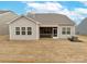 Rear exterior of home with neutral siding, large screened porch, and well-kept backyard and beautiful sky at 244 White Apple Way, Statesville, NC 28625