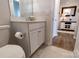 Neutral powder room featuring a white vanity with storage and a decorative mirror and lighting at 244 White Apple Way, Statesville, NC 28625