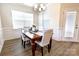 Bright dining room featuring a table with white cushioned chairs and wainscoting at 244 White Apple Way, Statesville, NC 28625