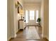 Bright entryway with wood floors, white trim, white front door and charming decor at 244 White Apple Way, Statesville, NC 28625