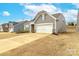 Charming single-Gathering home featuring a two-car garage and manicured landscaping at 244 White Apple Way, Statesville, NC 28625