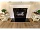Living room fireplace with dark marble surround and white mantle plus decor on side tables at 244 White Apple Way, Statesville, NC 28625