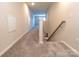 Bright hallway featuring neutral walls and carpet, leading to additional rooms in the house at 244 White Apple Way, Statesville, NC 28625