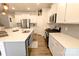 Bright, open kitchen with an island, white cabinetry, and stainless steel appliances at 244 White Apple Way, Statesville, NC 28625