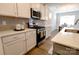 Modern kitchen featuring stainless steel appliances, subway tile backsplash, and white cabinets at 244 White Apple Way, Statesville, NC 28625