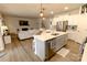 Open-concept kitchen with an island and stainless steel appliances open to the living area at 244 White Apple Way, Statesville, NC 28625