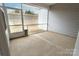 Relaxing screened-in porch with a concrete floor, offering a comfortable and shaded outdoor living space at 244 White Apple Way, Statesville, NC 28625