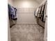 Walk-in closet featuring lots of hanging storage and a plush neutral carpet at 244 White Apple Way, Statesville, NC 28625