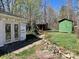 The backyard features two storage sheds, stone walkways, and a home undergoing renovation at 2546 Amber Crest Dr, Gastonia, NC 28052