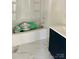 Bathroom features a white tub, new marble flooring and a modern dark vanity for a relaxing retreat at 2546 Amber Crest Dr, Gastonia, NC 28052