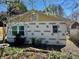 A home's exterior undergoing renovation is surrounded by mature trees and backyard foliage at 2546 Amber Crest Dr, Gastonia, NC 28052