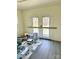A room being renovated featuring hardwood floors, paint supplies, and access to outside at 2546 Amber Crest Dr, Gastonia, NC 28052