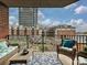 Inviting balcony with outdoor seating and stunning views of the community amenities and cityscape at 300 W 5Th St # 402, Charlotte, NC 28202