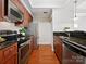 Gourmet kitchen showcasing stainless steel appliances, wood floors, and granite countertops at 300 W 5Th St # 402, Charlotte, NC 28202
