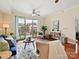 Bright living room with hardwood floors, a ceiling fan, and sliding glass doors to a balcony at 300 W 5Th St # 402, Charlotte, NC 28202
