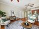 Bright living room with hardwood floors, a ceiling fan, and an open view to the kitchen at 300 W 5Th St # 402, Charlotte, NC 28202