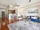Bright living room with hardwood floors, a ceiling fan, and an open view to the kitchen at 300 W 5Th St # 402, Charlotte, NC 28202