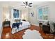 Bright bedroom with a large window, wood floors, and a comfortable seating area at 300 W 5Th St # 402, Charlotte, NC 28202