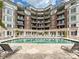 Beautiful pool with lounge chairs and a stone tile deck in front of luxury apartments at 300 W 5Th St # 402, Charlotte, NC 28202