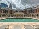Outdoor pool and lounge area in a brick apartment complex with the city skyline in the background at 300 W 5Th St # 402, Charlotte, NC 28202