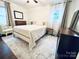 Comfortable bedroom with hardwood floors, a large window, and neutral décor at 3016 Hanson Dr, Charlotte, NC 28207