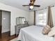 Well-lit bedroom with a dresser, ceiling fan, and view of outdoors at 3016 Hanson Dr, Charlotte, NC 28207