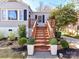 Charming front entrance with wooden stairs, manicured landscaping, and a welcoming atmosphere at 3016 Hanson Dr, Charlotte, NC 28207