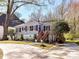 Quaint exterior of a light-colored home featuring well-maintained landscaping and a inviting wooden staircase at 3016 Hanson Dr, Charlotte, NC 28207
