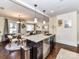 Open concept kitchen flowing into the dining area, with an island featuring a sink and dishwasher at 3016 Hanson Dr, Charlotte, NC 28207
